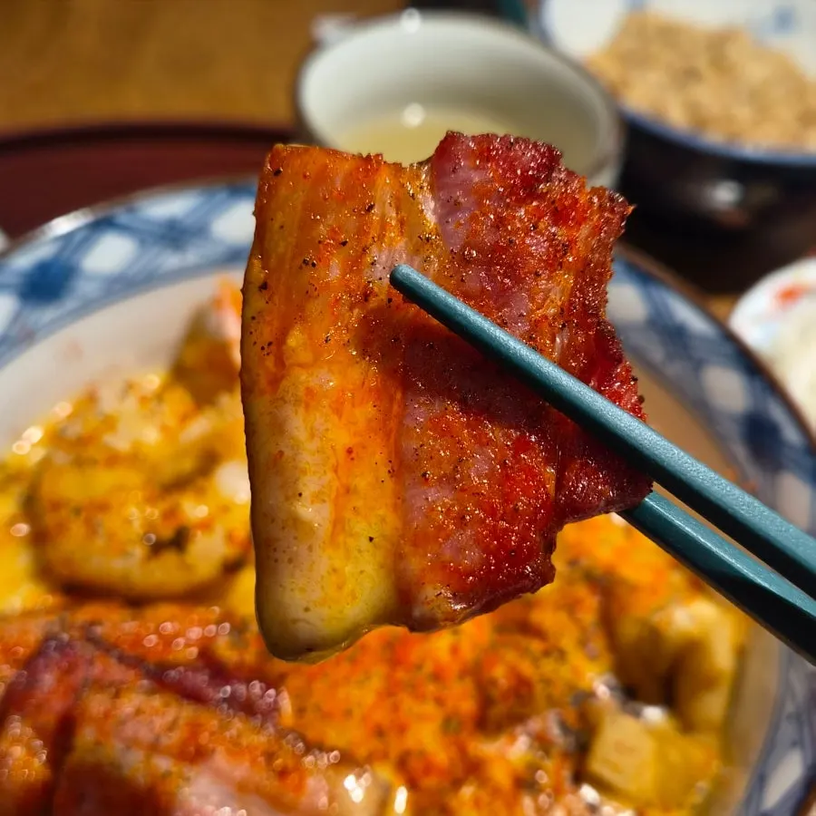 A bite of shrimp and pork belly bacon with the noodles