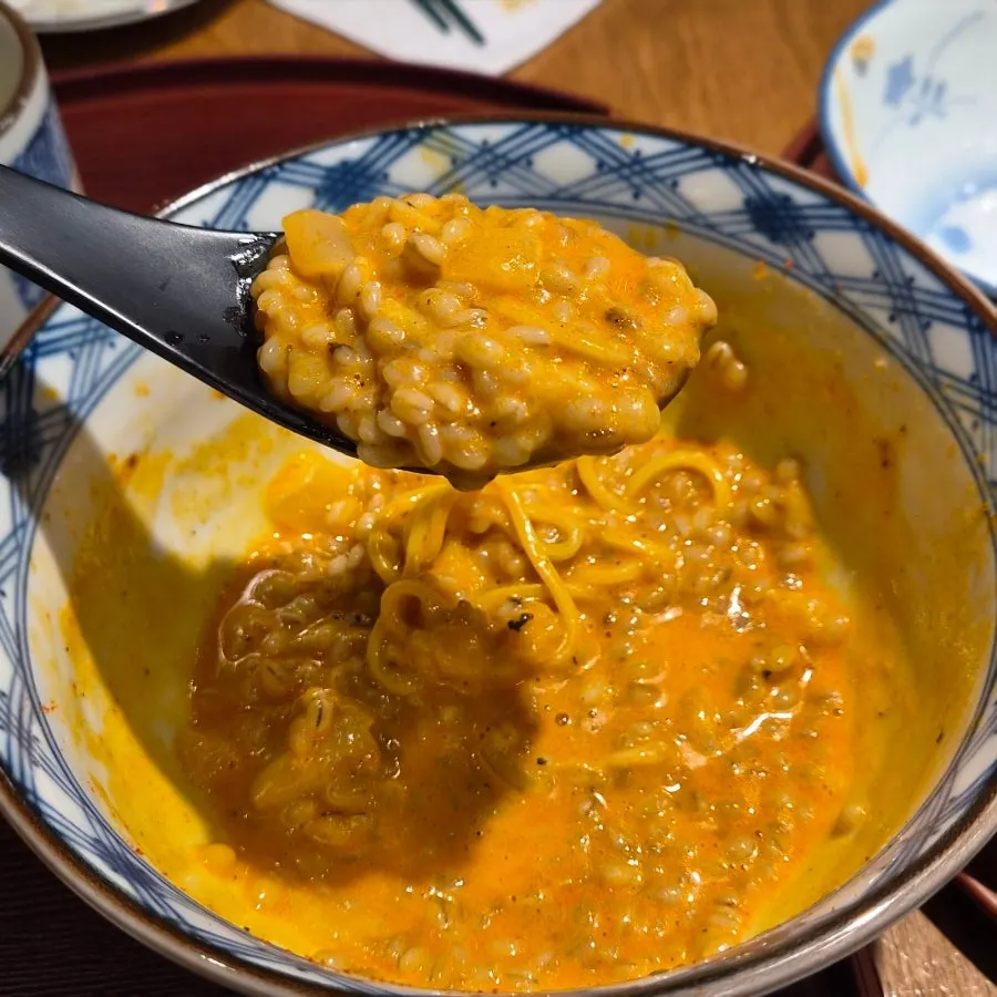 A spoonful of rice soaked in the sauce