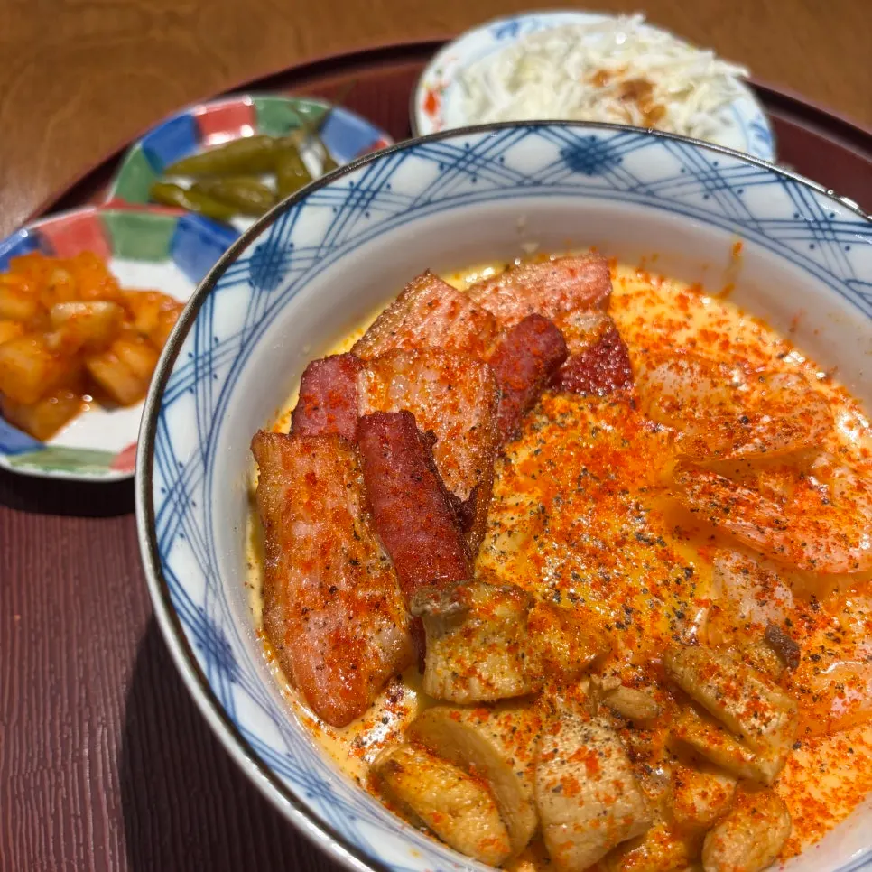 Side dishes of pickled chili, diced radish kimchi, and salad