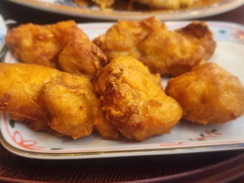 Piece of karaage dipped in sauce