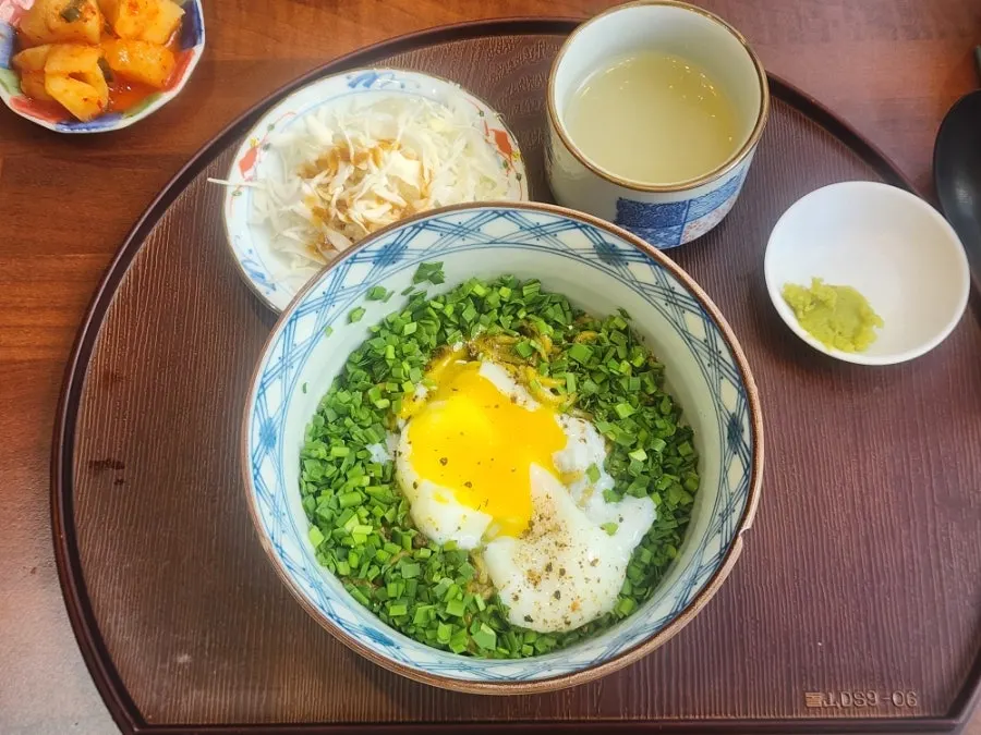 Basil soba topped with scallions and egg