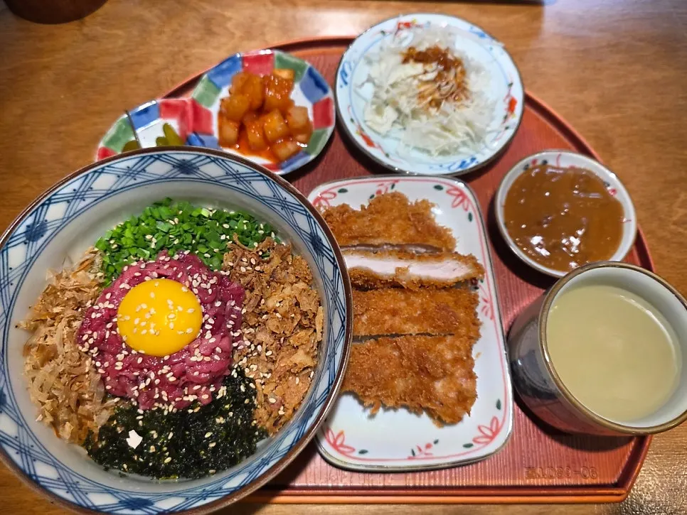 Table spread with yukhoe rice bowl and pork cutlet