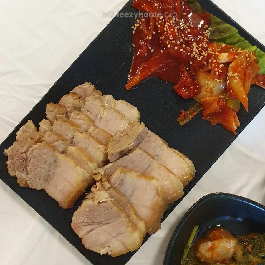 Bossam served with pollock sikhae and green onion kimchi