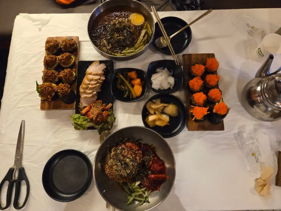 Group shot of mak-guksu, buckwheat gimbap, and boiled pork