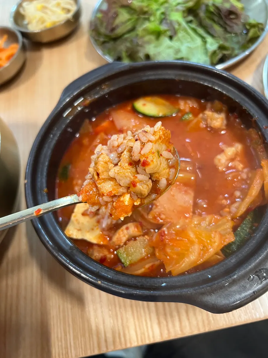 A spoonful of Spam kimchi stew with rice mixed in