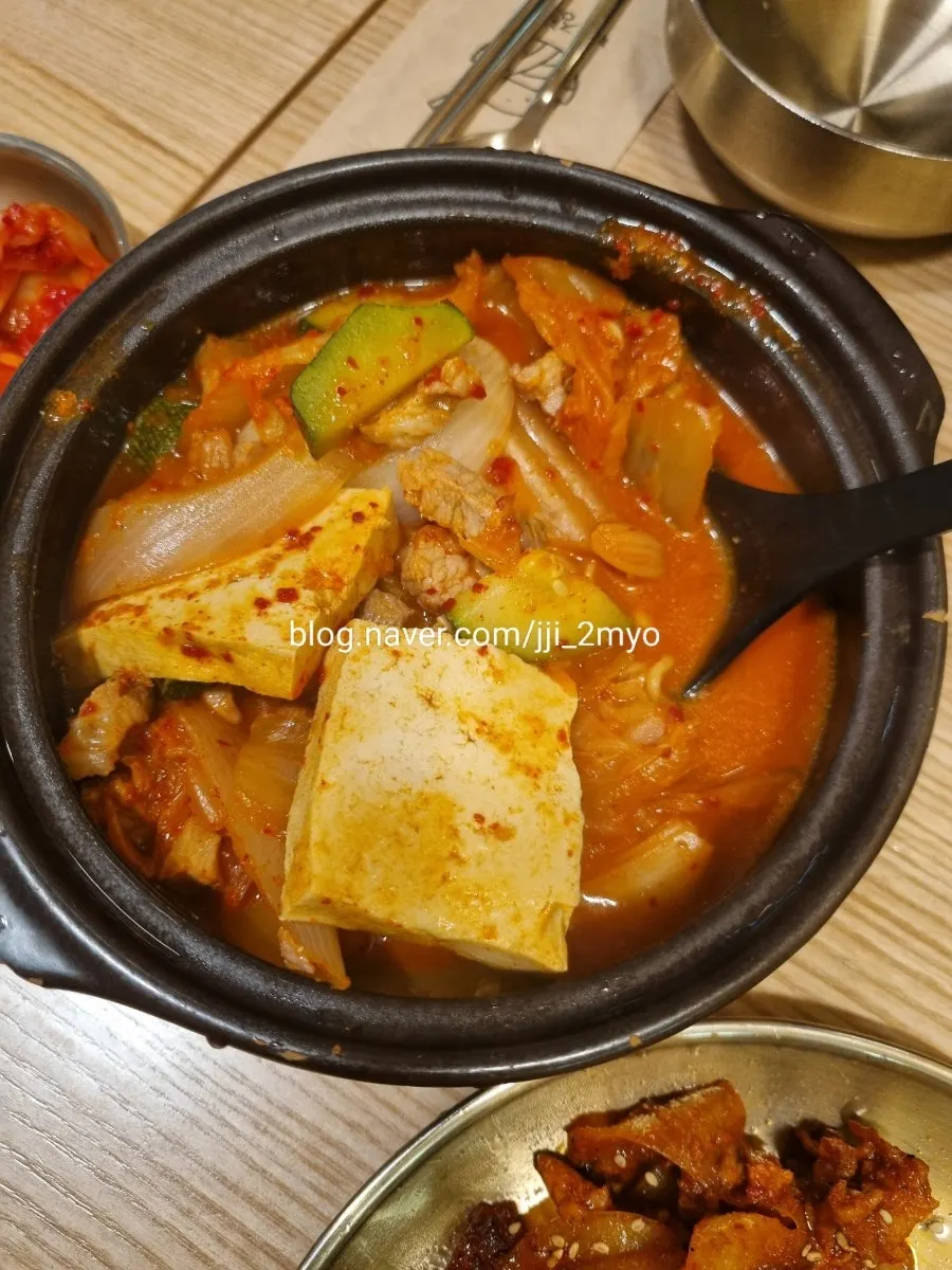 Spicy kimchi stew served generously in a stone pot