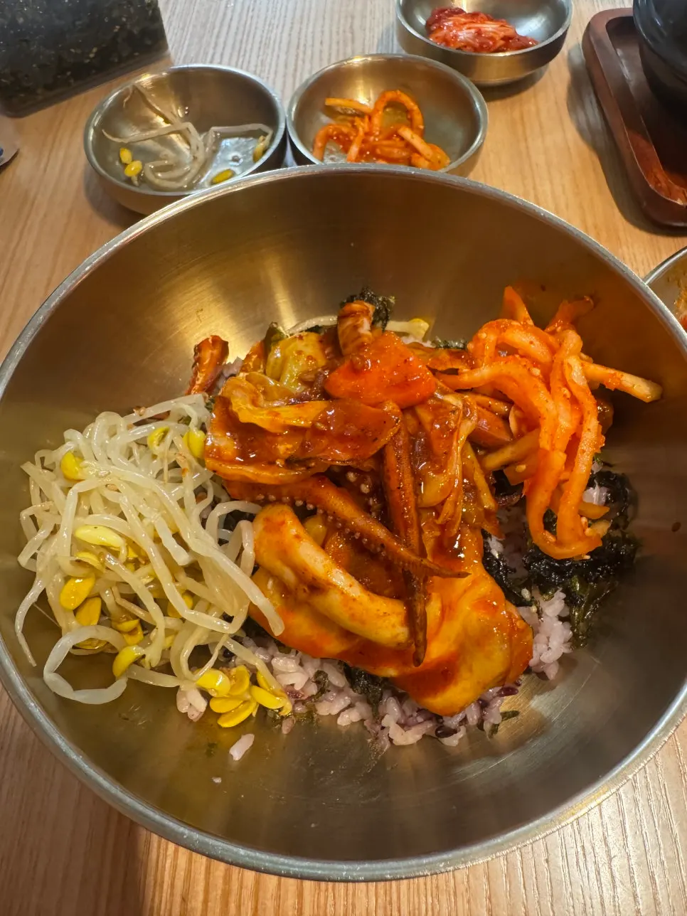 Rice being mixed with bean sprouts and julienned radish