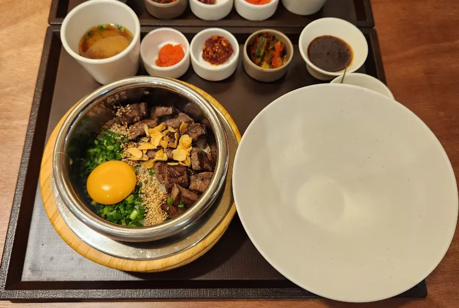 Steak sotbap topped with wagyu and egg yolk