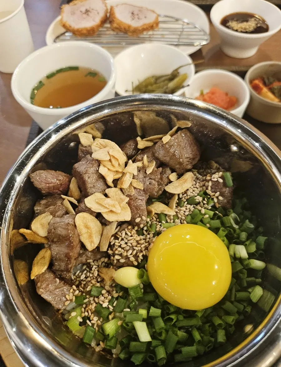 Steak sotbap topped with egg yolk
