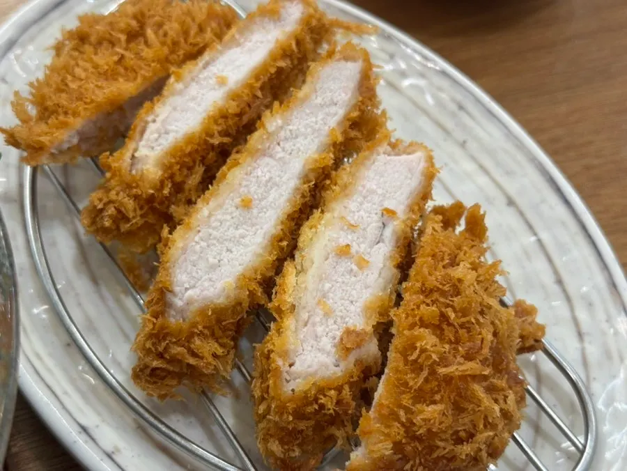 A spoonful of pot rice paired with tonkatsu