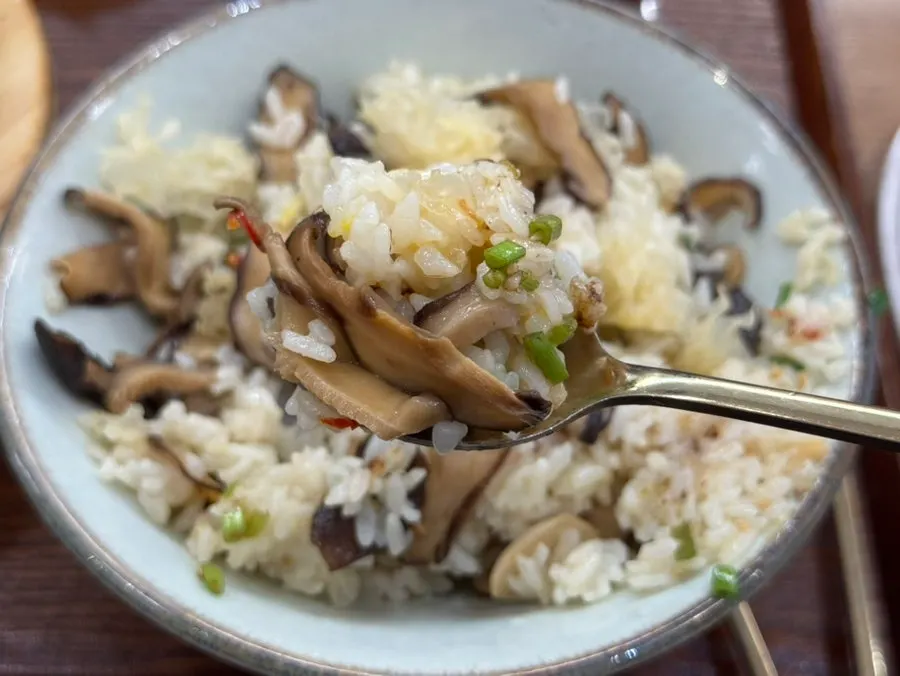A spoonful of rice topped with minari seasoning sauce