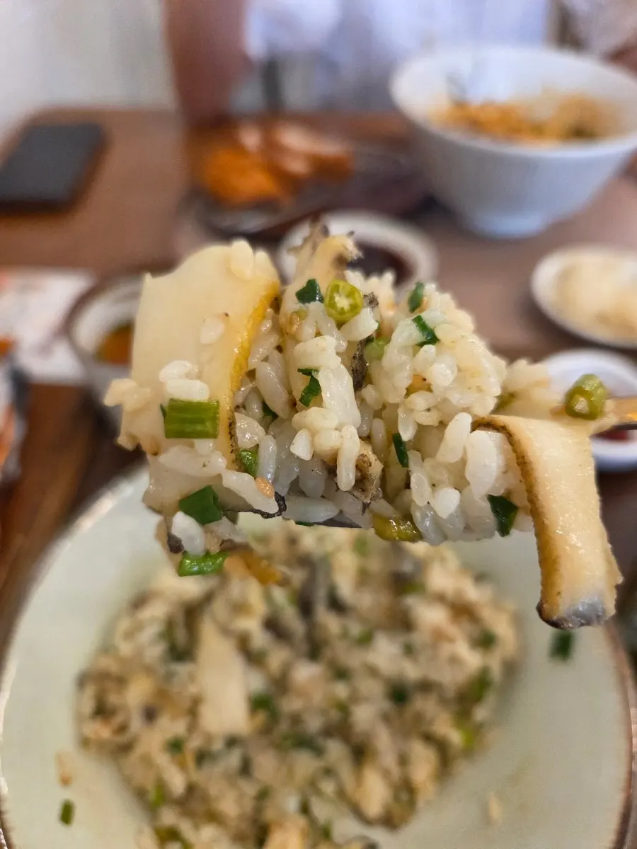 Abalone pot rice mixed and scooped out into a bowl