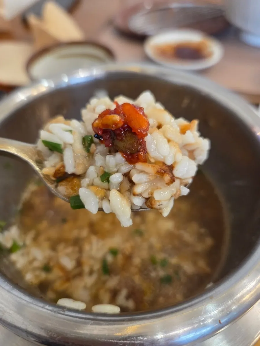 A bite of abalone pot rice wrapped in seaweed