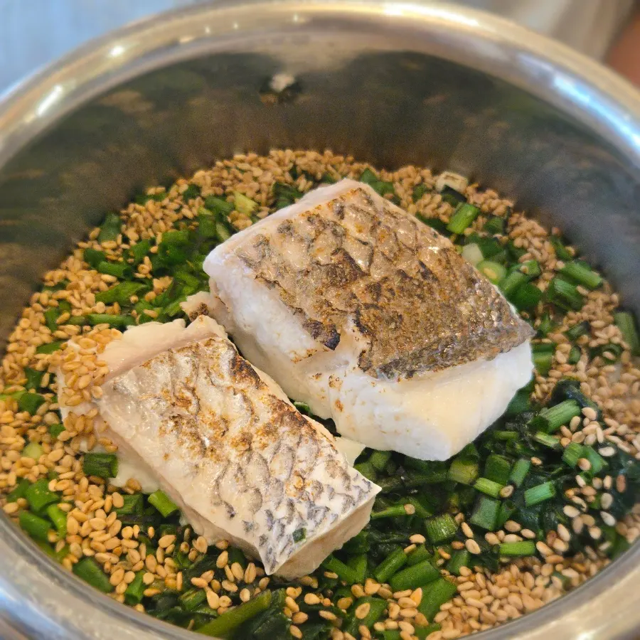 Wild sea bream pot rice topped with spring greens