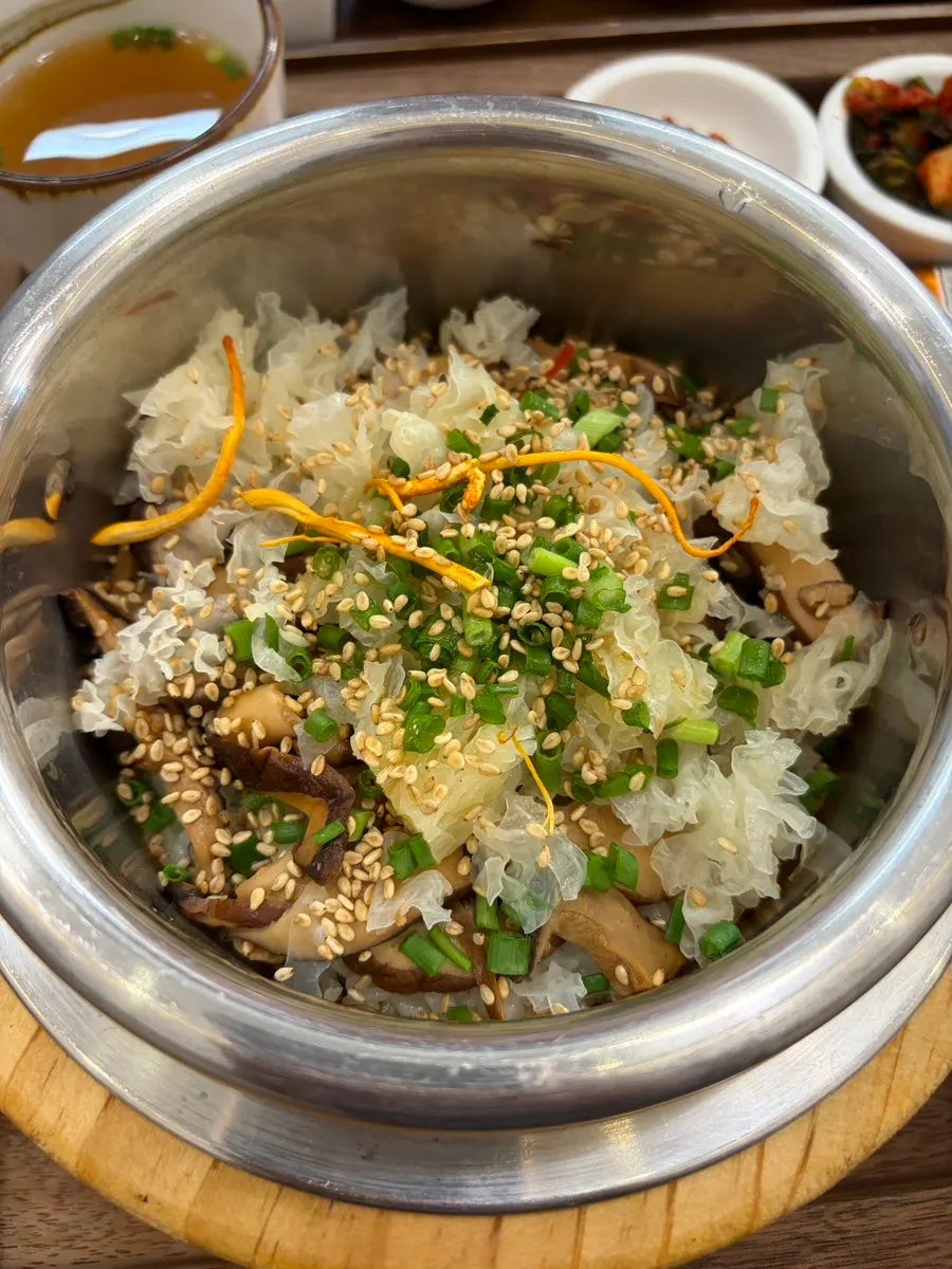 Bowl of perilla oil mushroom pot rice with rice scooped out