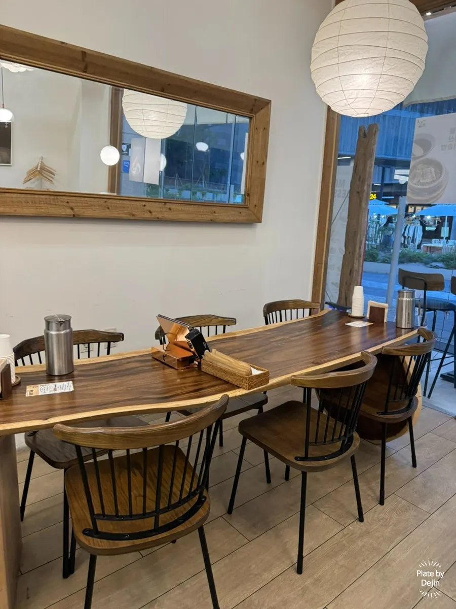 Table seating and open kitchen at Gome Mui