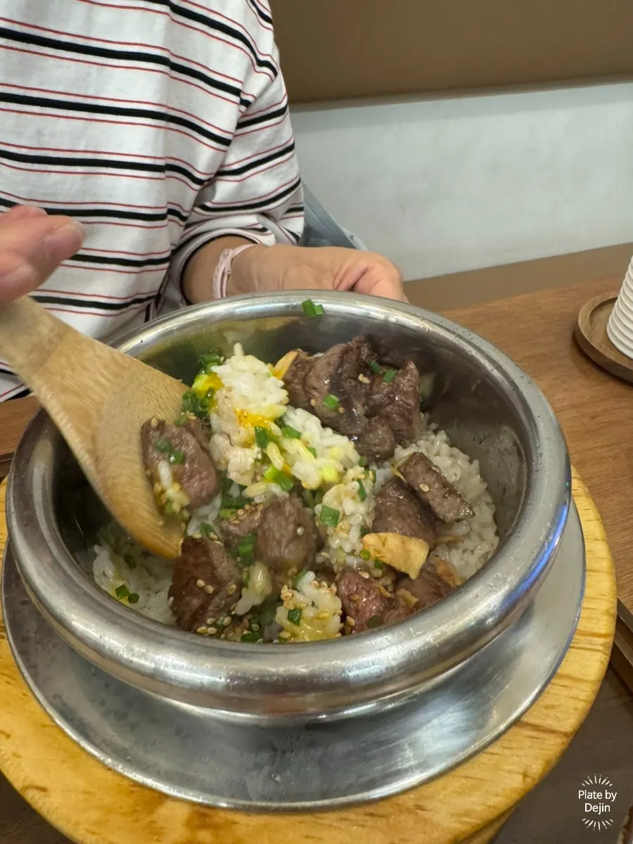 Mixing rice and meat with sauce inside the pot