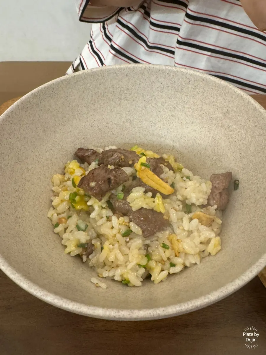 A spoonful of rice and meat from the steak pot rice
