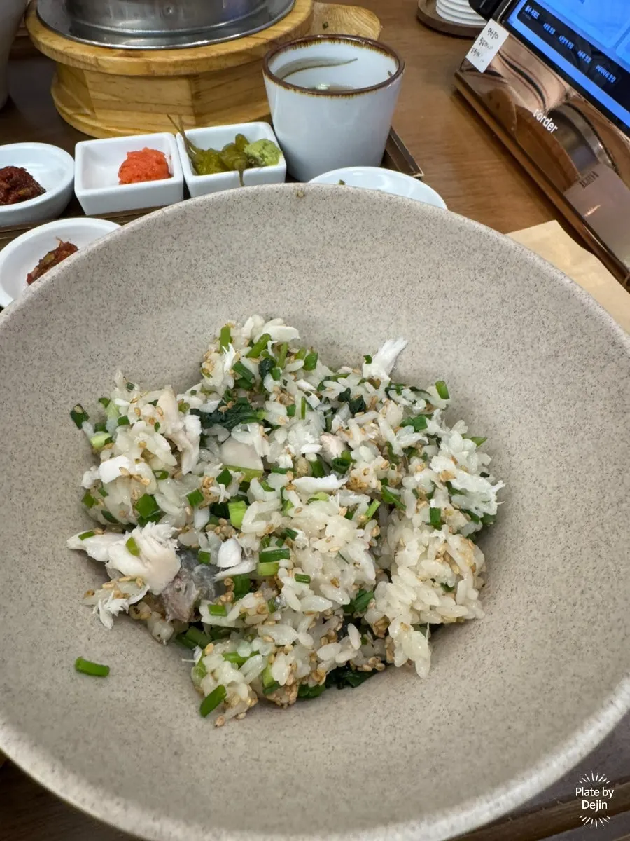 A bite of sea bream and rice wrapped in seaweed