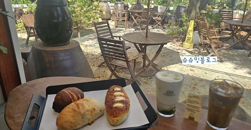 Wide shot of the Goyang bakery café with garden