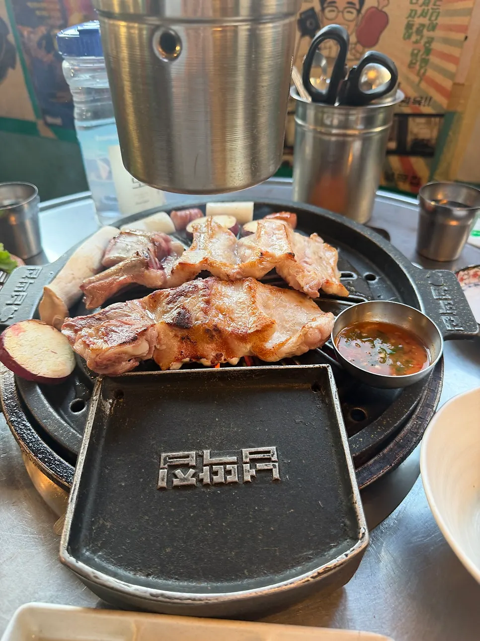 Black pork saeng-galbi cooking on the grill