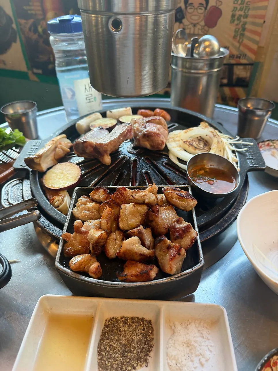 Black pork saeng-galbi cooking on the grill
