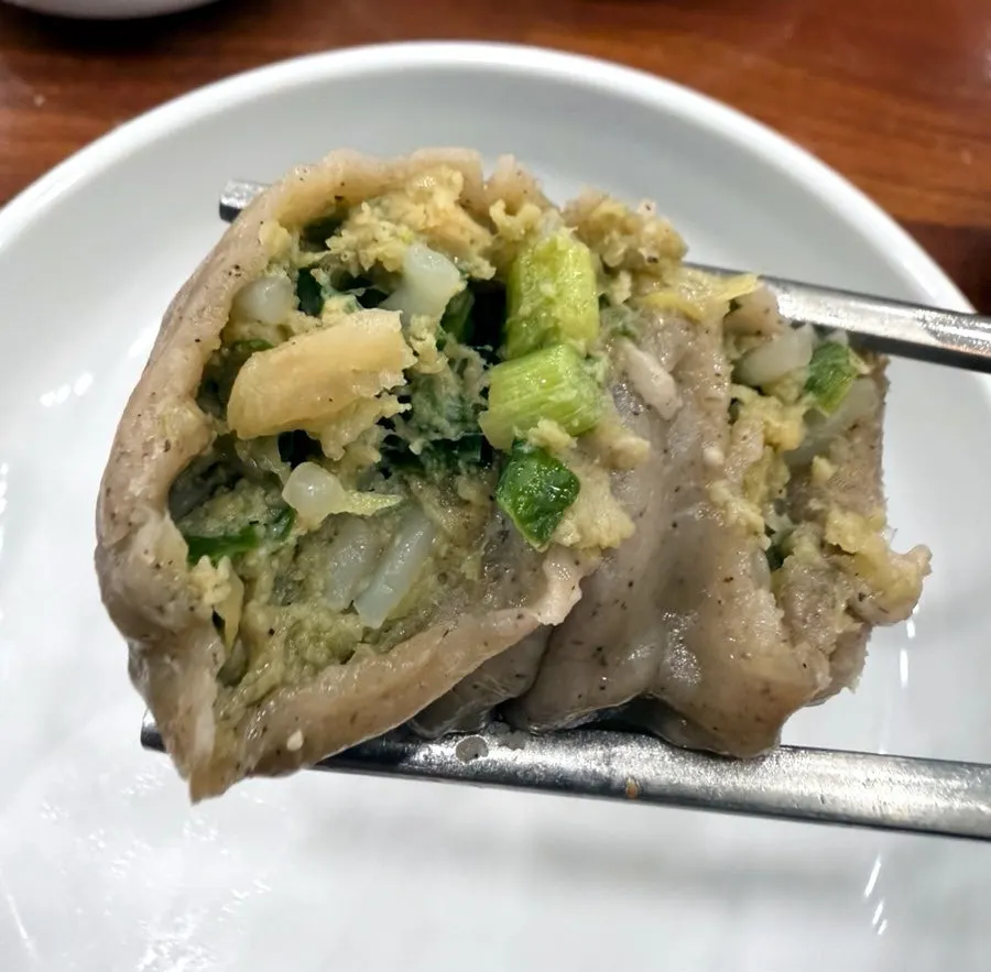 Cross-section of a mandu with thin wrapper filled with meat and vegetables