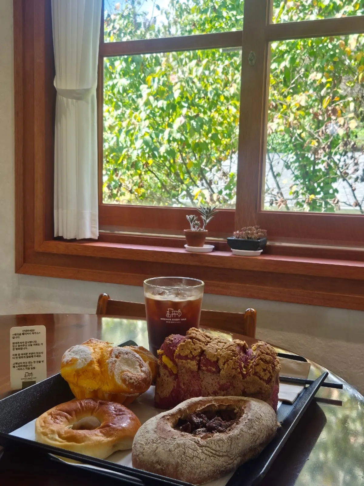 Ordered iced Americano and a spread of breads on the table