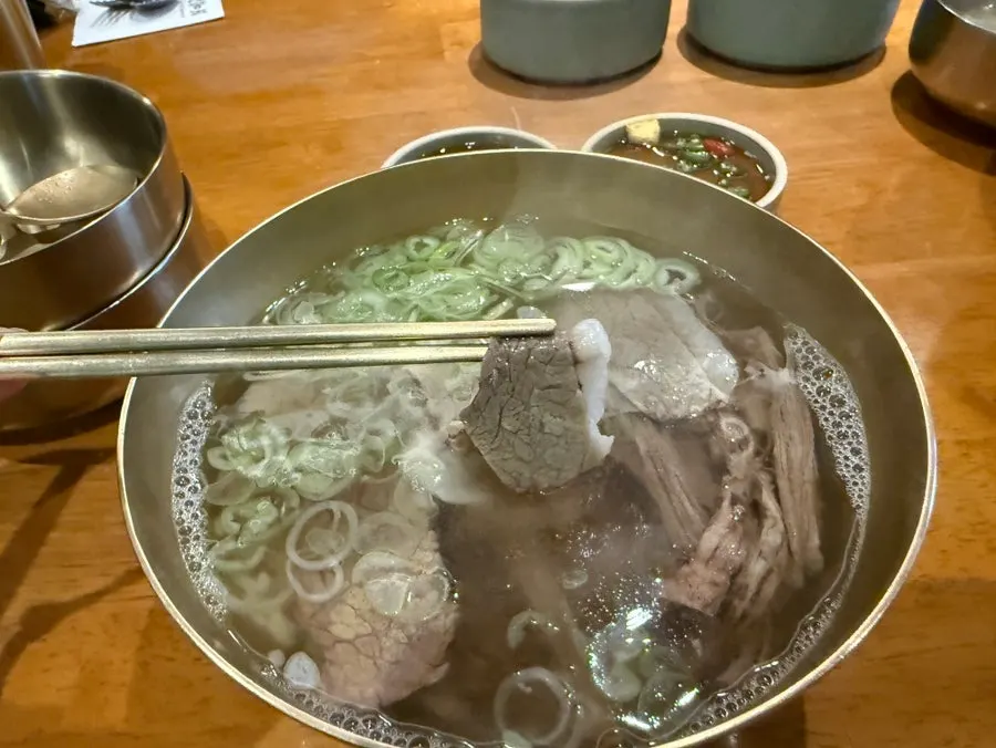 Clear beef broth with a piece of tender meat