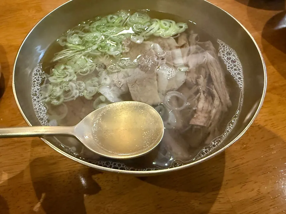 Table with clear beef gomtang (special) and beef yukhoe bibimbap
