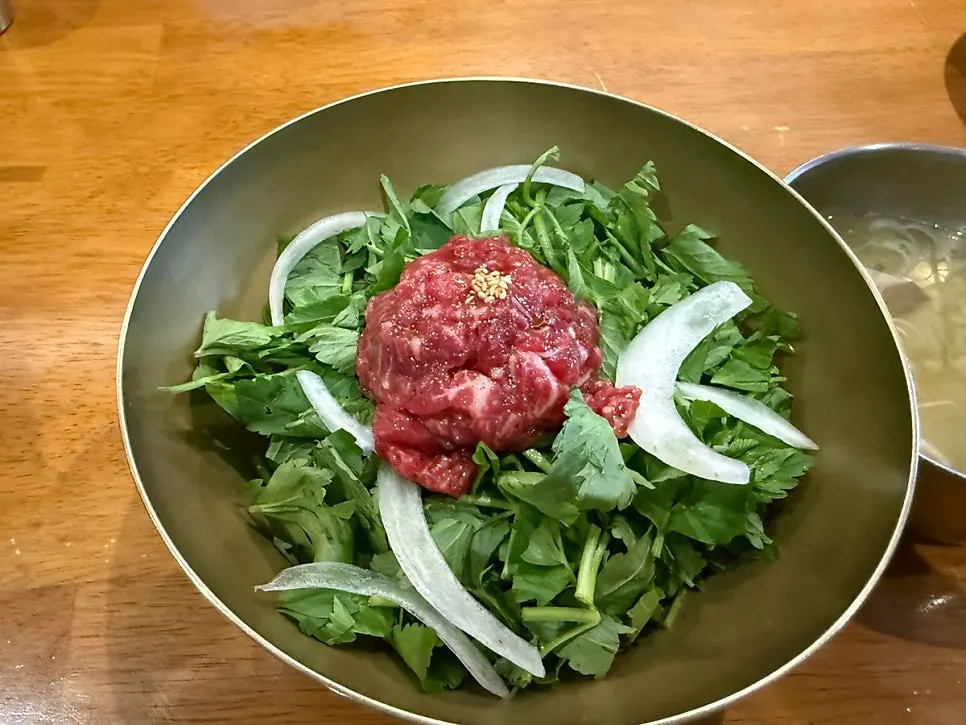 Thinly sliced beef with a spoonful of rice