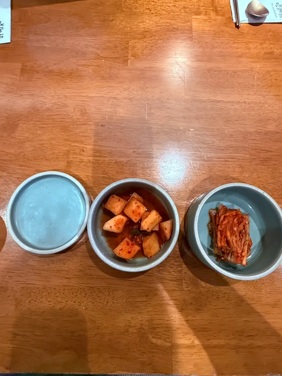 Salt, pepper, kimchi, and kkakdugi side dishes