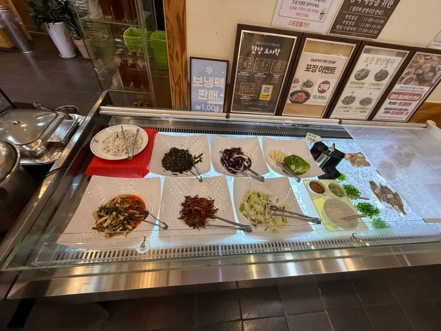 Salad, seasoned greens, and japchae side dishes