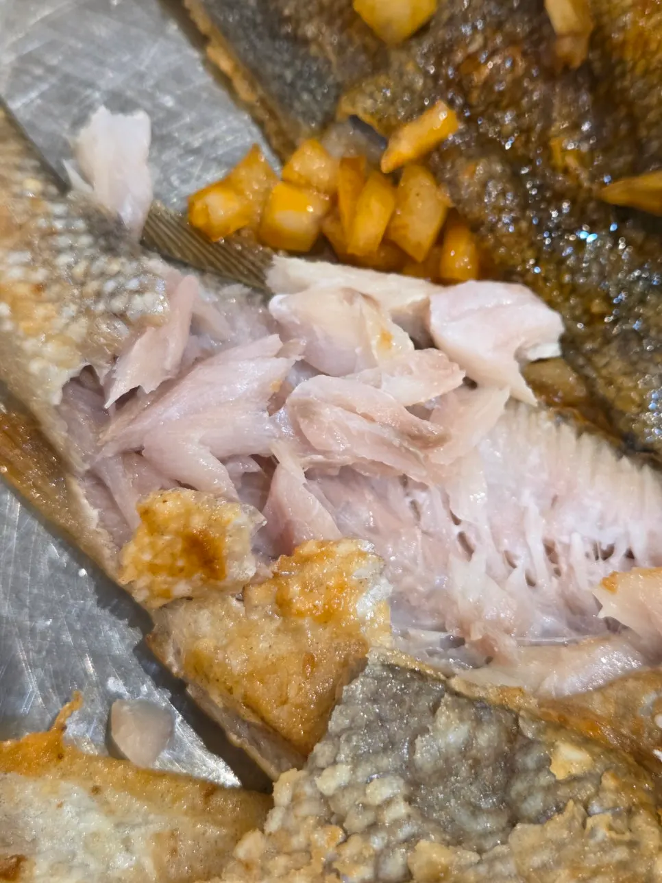 Seasonal grilled fish placed on the hot plate