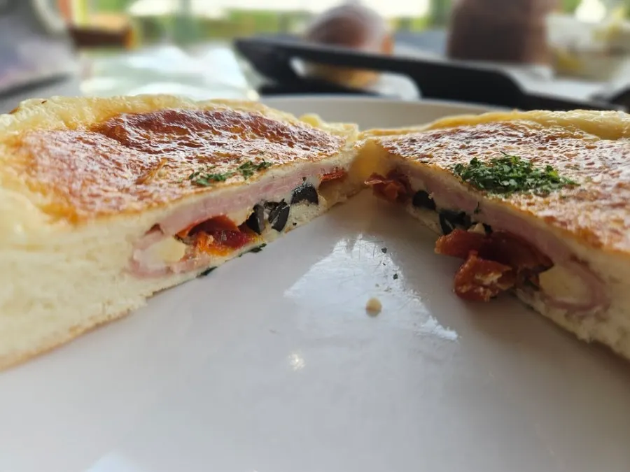 Cross-section of the tomato ham cheese bread cut in half