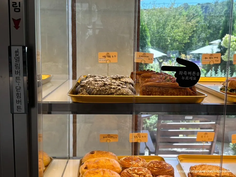 Bread case with a button-operated door