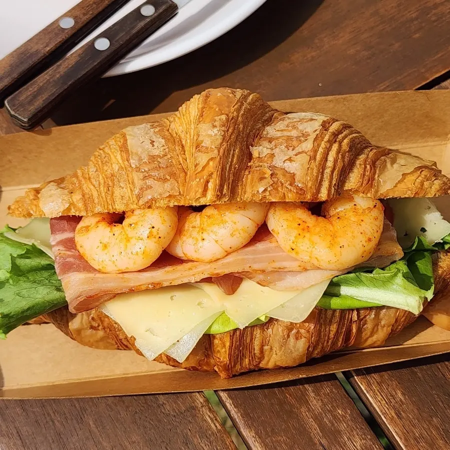 Bacon cheese shrimp croissant sandwich packed with plump shrimp