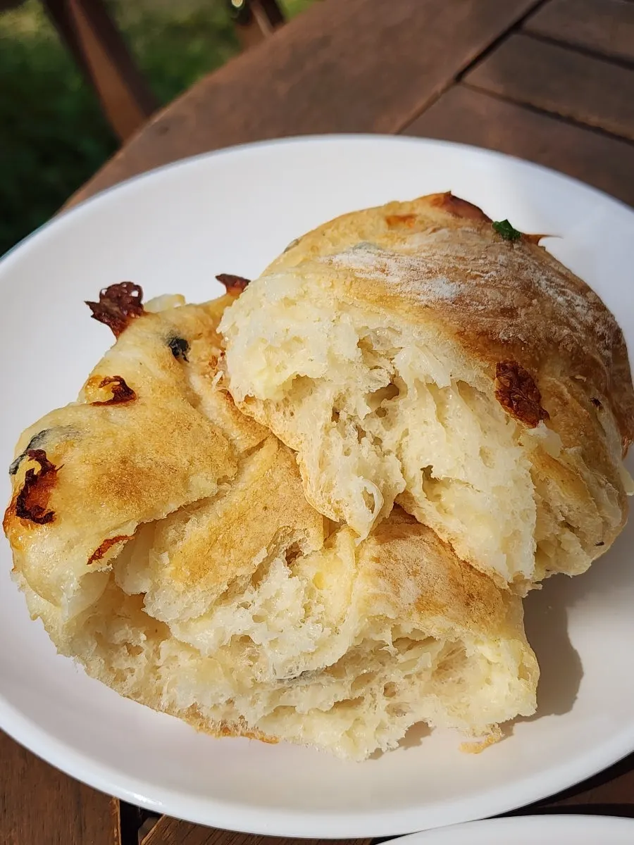 Bread and coffee set on the table under the parasol