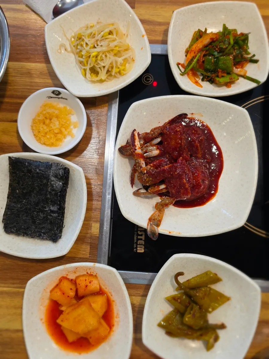 A piece of soy crab pressed open with meat sliding out