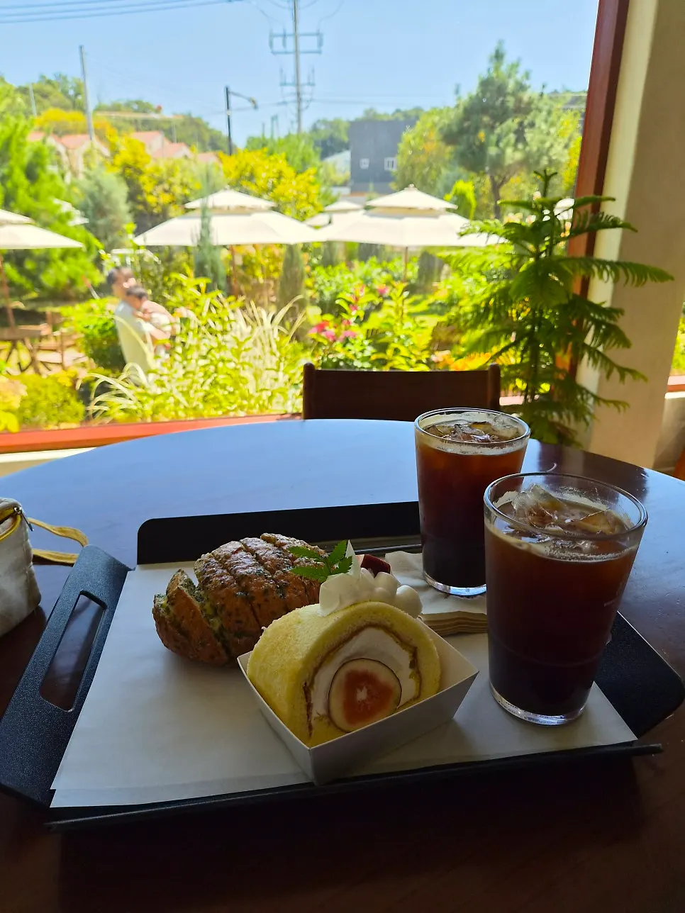 Geisha bean iced americano and bread order set on the table