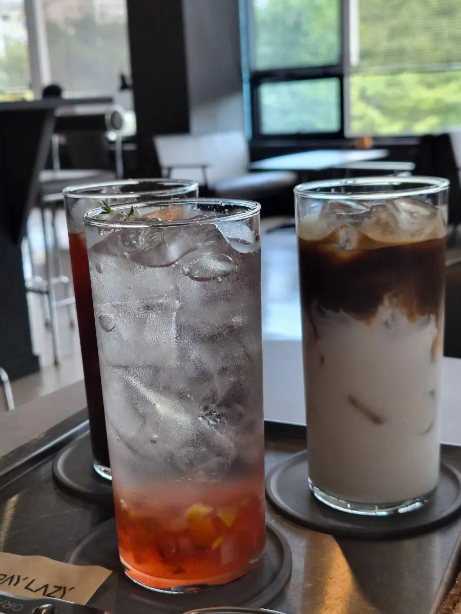 Coffee and dessert on a table by the floor-to-ceiling windows