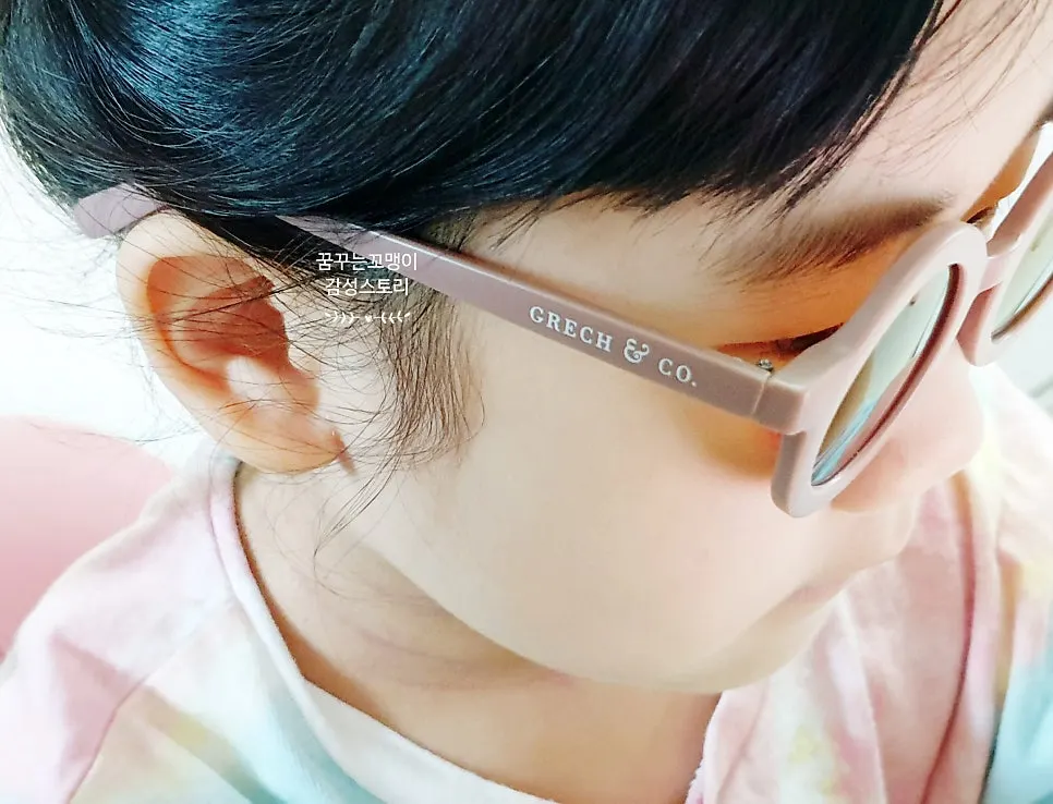 Child wearing lavender kids’ sunglasses