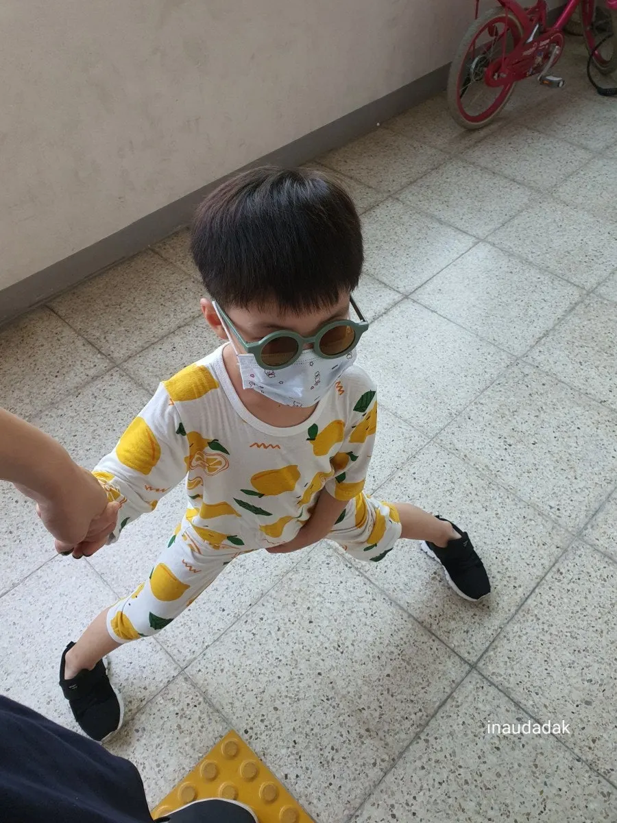 Child wearing mint-colored sunglasses