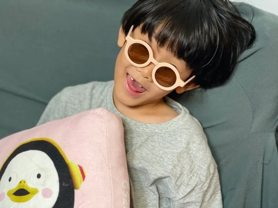 Siblings trying on sunglasses