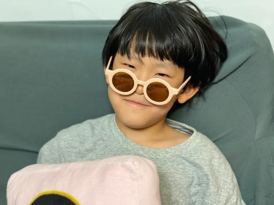 An 8-year-old wearing sunglasses