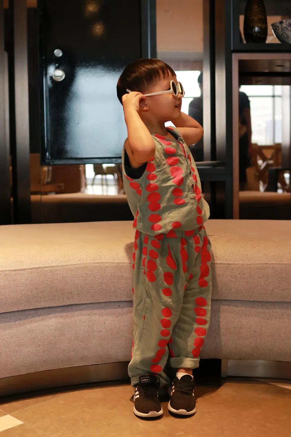Child wearing sunglasses in a vertical composition