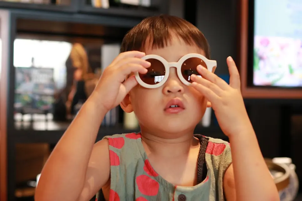 Child wearing white sunglasses