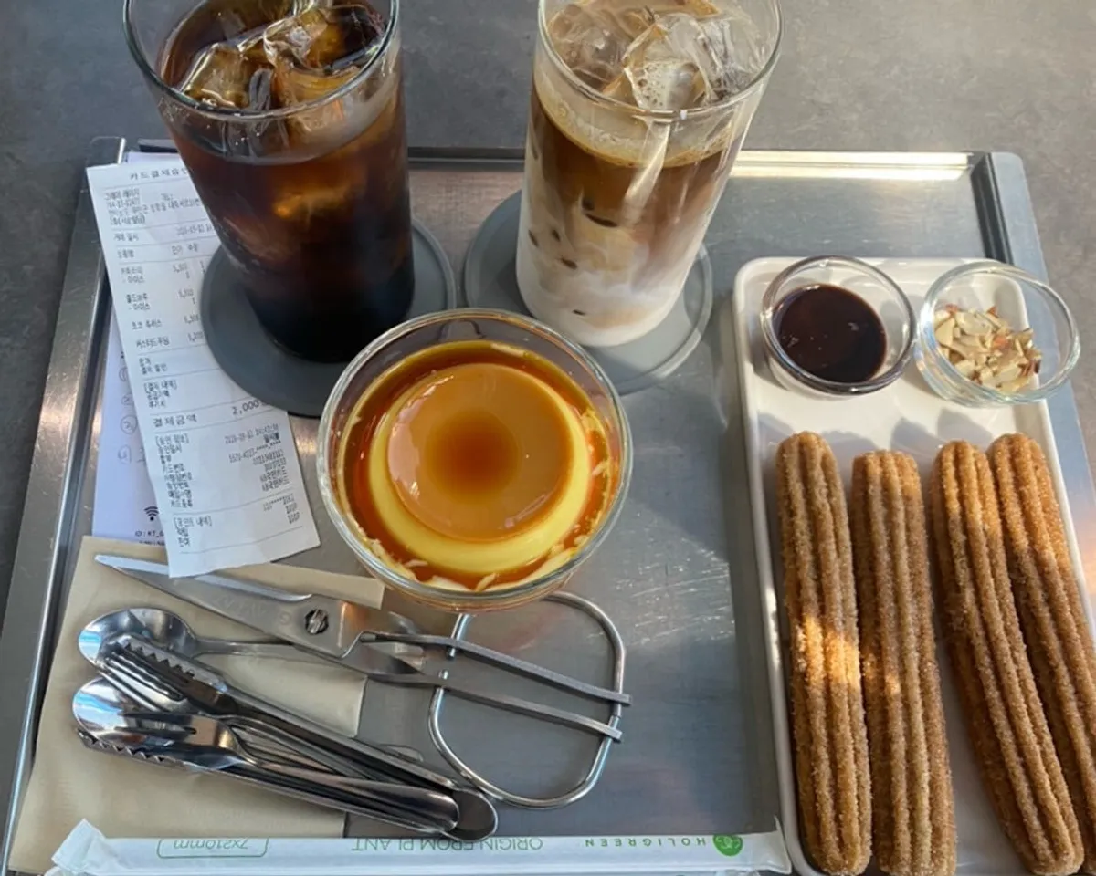 A table at GRAY LAZY with homemade cold brew and desserts