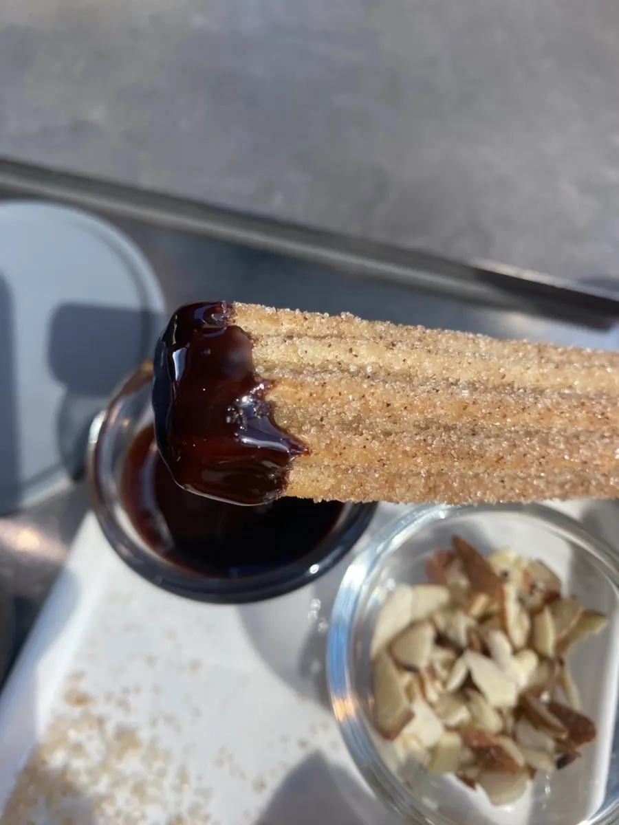 Cold brew and churros enjoyed together at the table