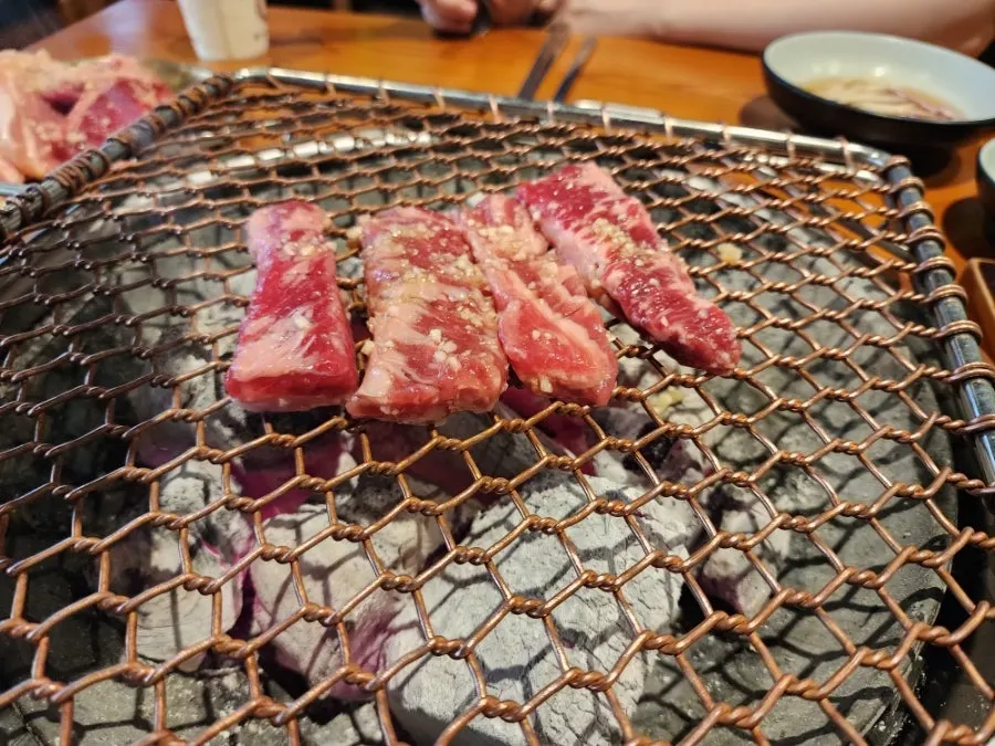 White charcoal fire at the center of the table
